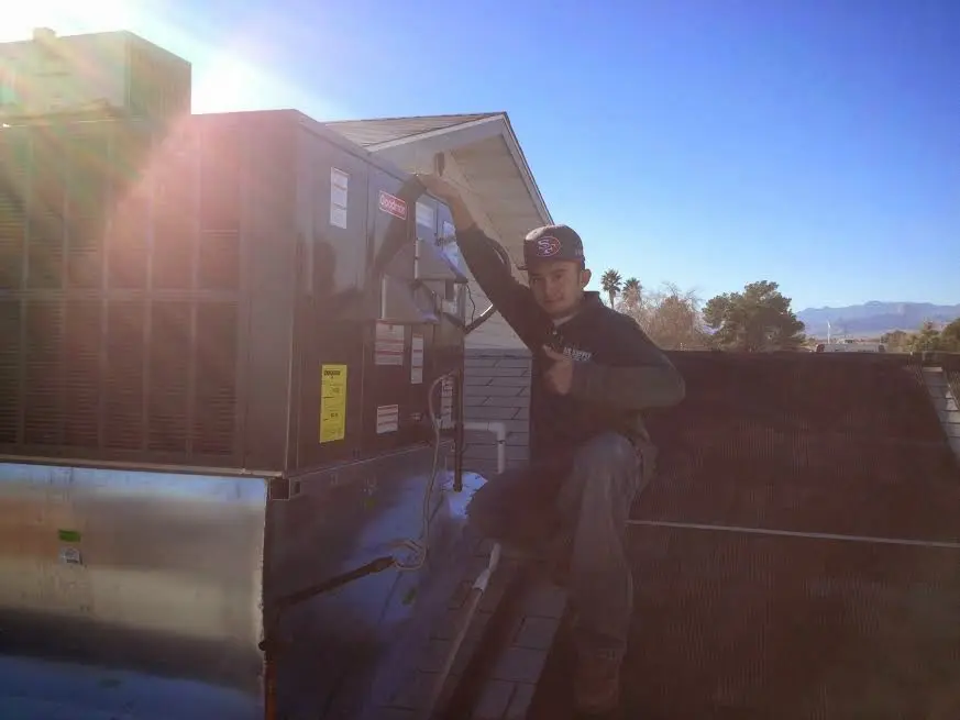 HVAC technician performing HVAC Inspection on a rooftop unit in St. Paul